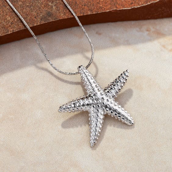 A silver necklace with a star pendant jewellery