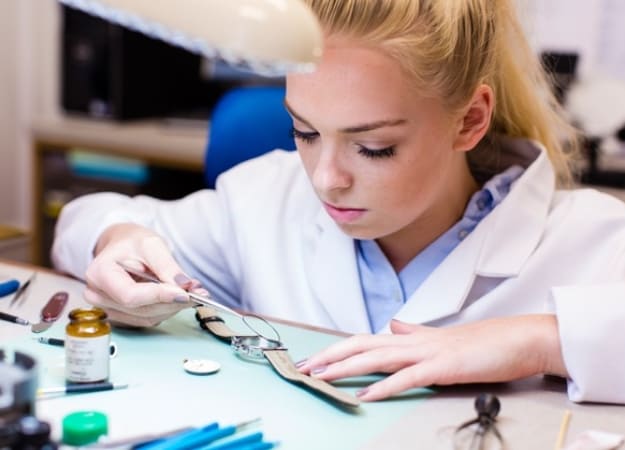 Woman expert replacing watch battery