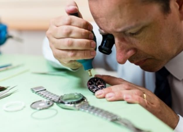 An experts repairing a broken watch.